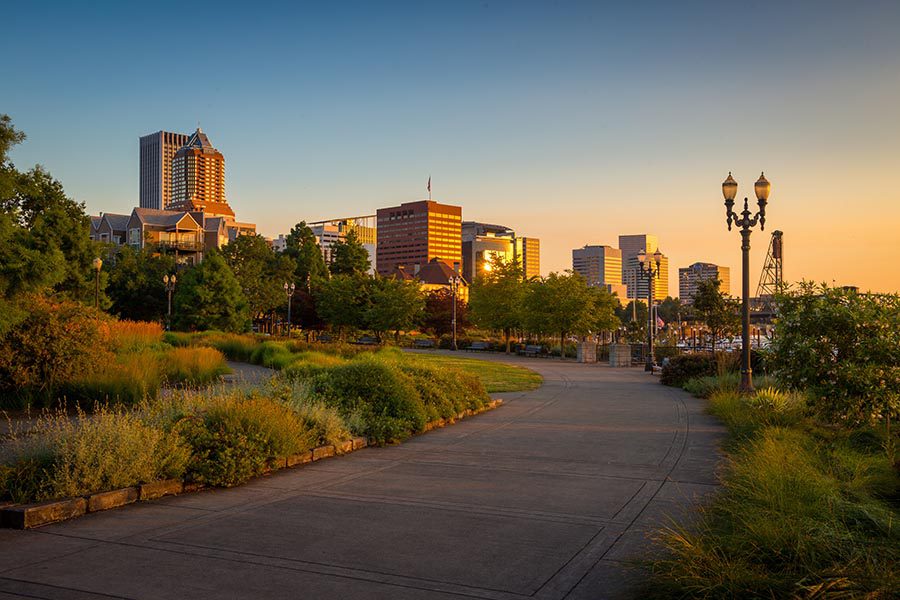 About Our Agency - Walking Path Surrounded by Landscaping Along the Waterfront in Portland, Oregon at Sunset