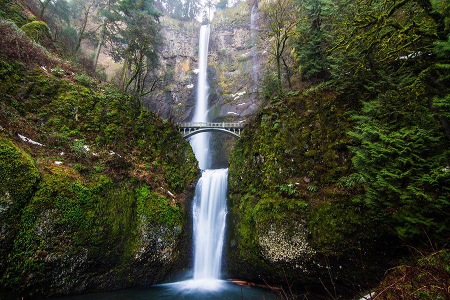 Contact - Multnomah Falls in Portland, Oregon With Lush Greenery and Walking Trails in the Rocks